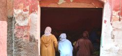 Local women buying groceries at a storefront in Marrakech, Morocco