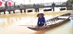 Woman With Rice Hat in Vietnam Woman on a boat in Hoi An, Vietnam