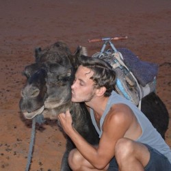 Robert Schrader kissing a camel in Morocco