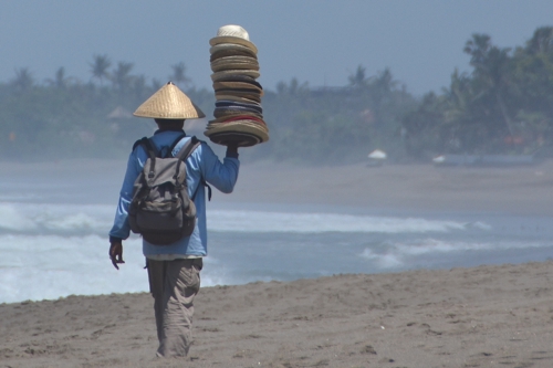 Beach Vendor Selling Hats Long Term Travel and Spending Habits