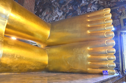 Visit Buddhist temples, such as Wat Pho in Bangkok