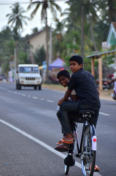 Boys biking in Arugam Bay Town