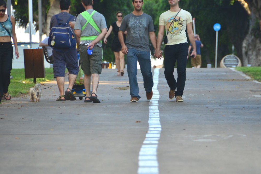 Gay couple holding hands on Ben Tsion Boulevard in Tel Aviv, Israel
