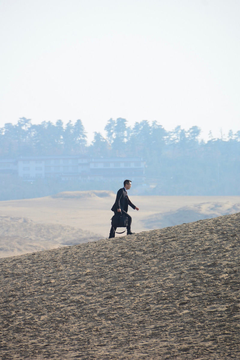 Salaryman in desert in Tottori, Japan