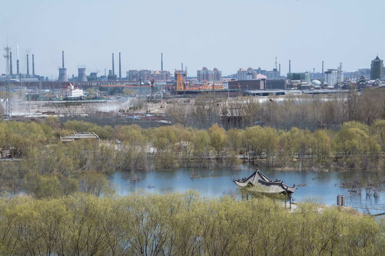 Pagoda with backdrop of power plants in China